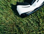 white and black virtual reality headset against grass