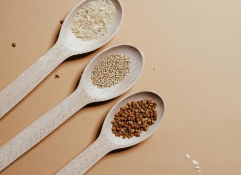 three white wooden spoons with different substances