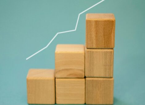 upward white arrow line stretching across vertically-stacked wooden block pieces