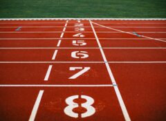 white-and-red runners race track start line