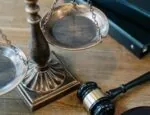 justice scales and gavel on wooden desk