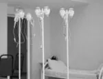 IVs hanging in a patient room of a health care facility