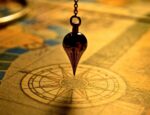 pendulum hanging over map navigation symbol