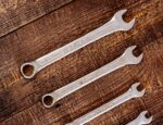 metal wrenches on wooden table