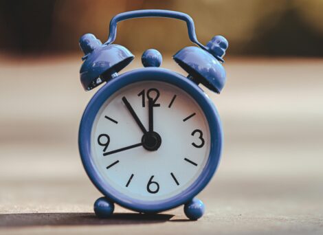 blue alarm clock with dial hands