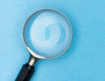 magnifying glass against light blue background