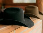 cowboy hats on brick rustic wall