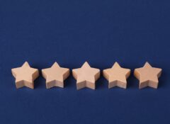 five wooden stars on dark blue background
